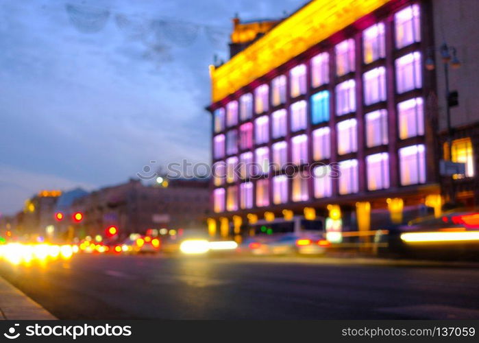 Light car trails on the modern city street at night. Blurred background