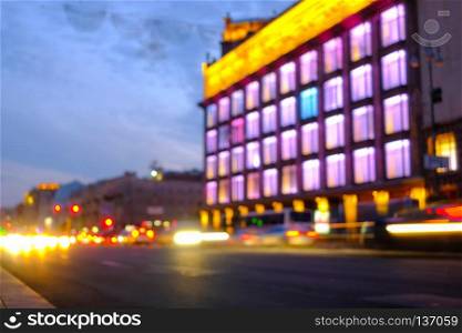 Light car trails on the modern city street at night. Blurred background