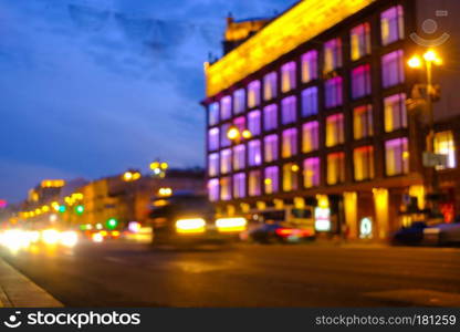 Light car trails on the modern city street at night. Blurred background