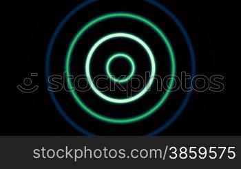 Light circles disperse and die away against a dark background