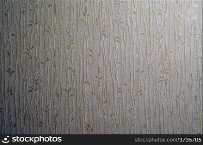 Light creamy texture of wallpaper with a pattern of golden sprigs