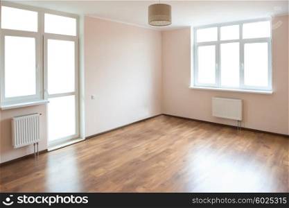 Light empty room with big white isolated windows and wooden floor