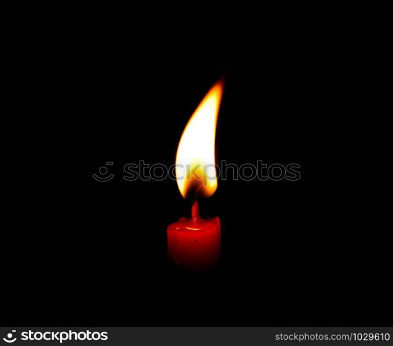 light flame candle burning brightly on black background