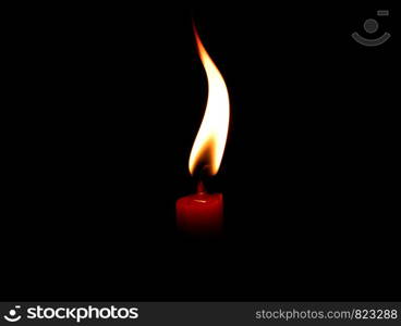 light flame candle burning brightly on black background