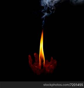 light flame candle burning brightly wiht smoke on black background