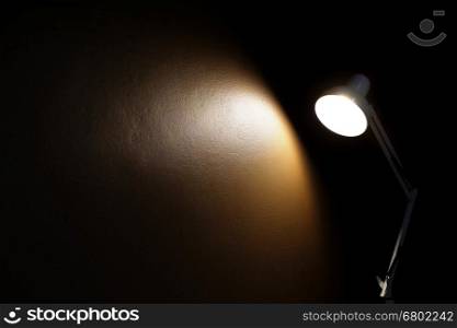 light from table lamp on the brown wall