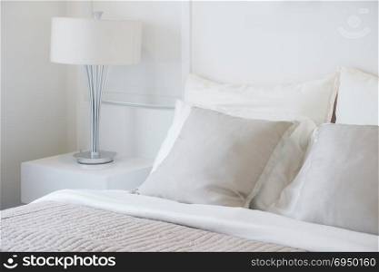 Light gray pillow setting on bed in nice vibe bedroom modern interior style