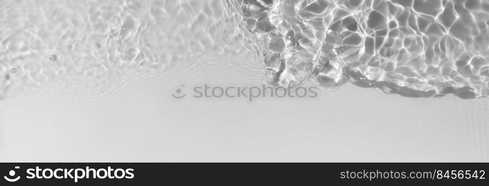 Light gray transparent clear calm water surface texture with splashes, waves and bubbles. Trendy abstract nature background. Water waves in sunlight. Long banner. Light gray transparent clear calm water surface texture with splashes, waves and bubbles. Trendy abstract nature background. Water waves in sunlight. Long banner.