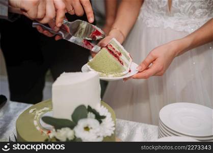 Light green small cake cut at the wedding.. A cake in two tiers with a greenish color of the decor 3885.