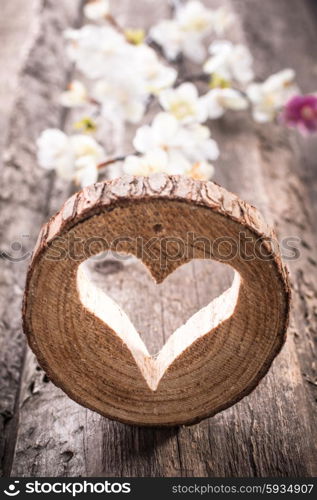 Light heart on rustic wooden background