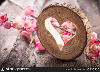 Light heart on rustic wooden background
