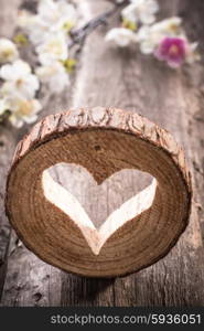 Light heart on rustic wooden background