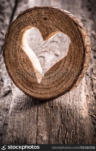 Light heart on rustic wooden background