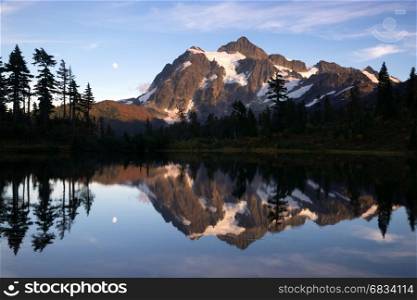 Light hits Mt Shuksan well at sunset above picture lake