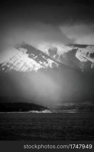 Light illuminates a snow squall across Abraham Lake in Alberta, Canada.