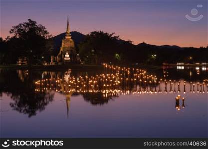 light in Buddha Statue at Temple in Loy Kratong Festival, Sukhothai Historical park , Thailand