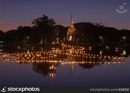 light in Buddha Statue at Temple in Loy Kratong Festival, Sukhothai Historical park , Thailand