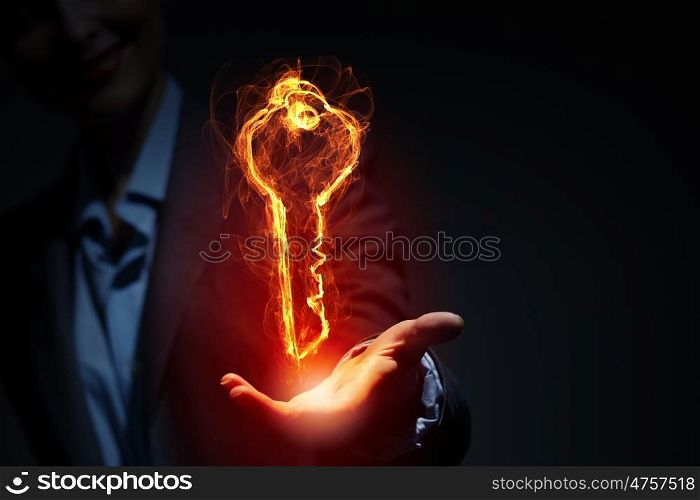 Light key icon. Glowing light key sign in palm on dark background