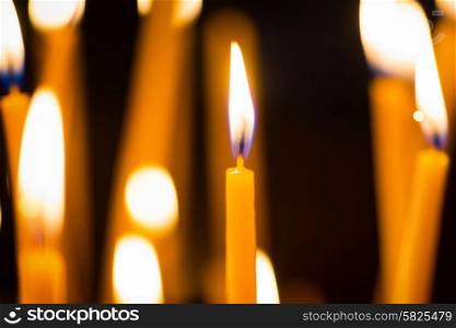 Light of candles in the church on the black background