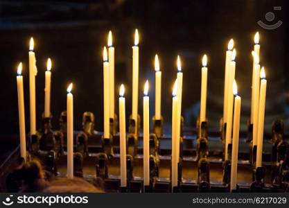 Light of candles in the church on the black background