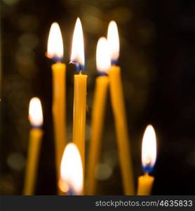Light of candles in the church with dark background