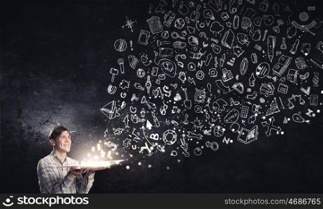 Light of education in darkness. Young man with book in hands and characters flying out
