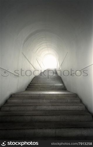 Light of the end of tunnel with ascending stairs