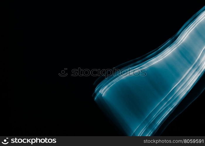 Light painted glowing abstract blue and white curved lines on a black background