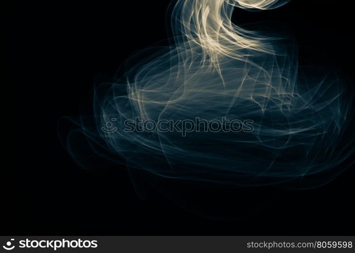 Light painted glowing abstract blue and yellow curved lines on a black background