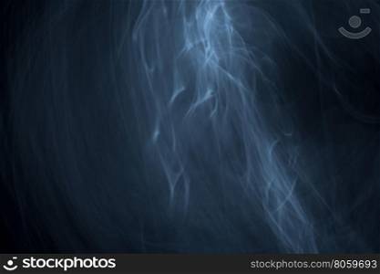 Light painted glowing abstract light blue and white curved lines on a black background