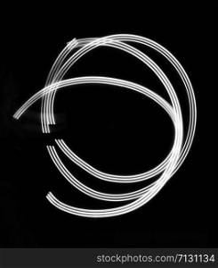 Light painting art photograph with black background. Long exposure photo with multicolor spinning lights. Art background suitable for print and design template in black and white.