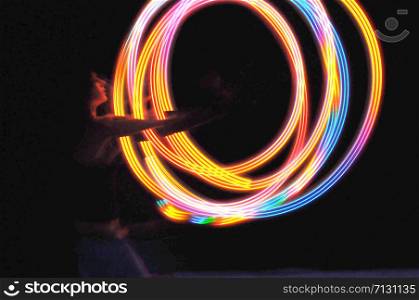 Light painting art photograph with black background. Long exposure photo with multicolor spinning lights. Art background suitable for print and design template.