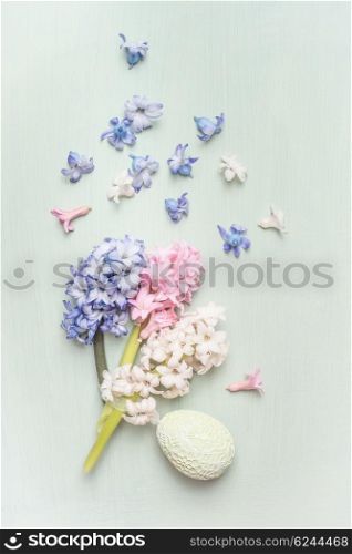 Light pastel Easter greeting card with hyacinths flowers and egg, top view