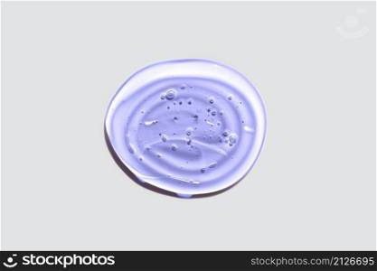 Light purple or violet transparent oval gel drop isolated on white background. Top view. Virus protection or cosmetics concept. Face Serum texture Trendy banner with 2022 color of the year very peri.. Light purple or violet transparent oval gel drop isolated on white background. Top view. Virus protection or cosmetics concept. Face Serum texture Trendy banner with 2022 color of the year very peri