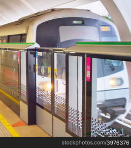 Light rail transit train arrives at a station in Singapore. Metro train motion blur