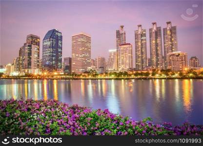 Light reflect water beautiful building river twilight purple sky with bougainvillea flowers at Bangkok Thailand