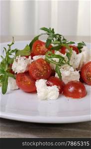 light salad of arugula with cherry tomatoes and mozzarella