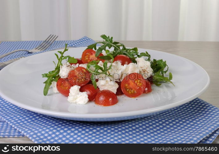 light salad of arugula with cherry tomatoes and mozzarella