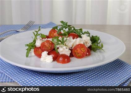 light salad of arugula with cherry tomatoes and mozzarella