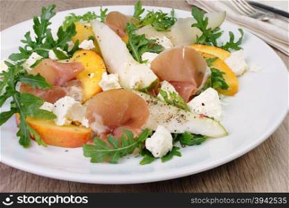 Light salad of pear, peach and ham, feta, arugula