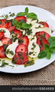 Light snack caprese with strawberries and mozzarella dressed mint pesto