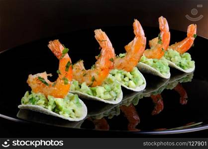 light snack of crisps with avocado filling and fried shrimp flavored with herbs.