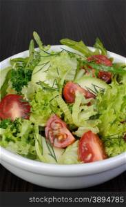 Light summer salad of lettuce with arugula and cherry tomatoes