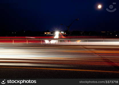 Light trails of evening highway. Urban background