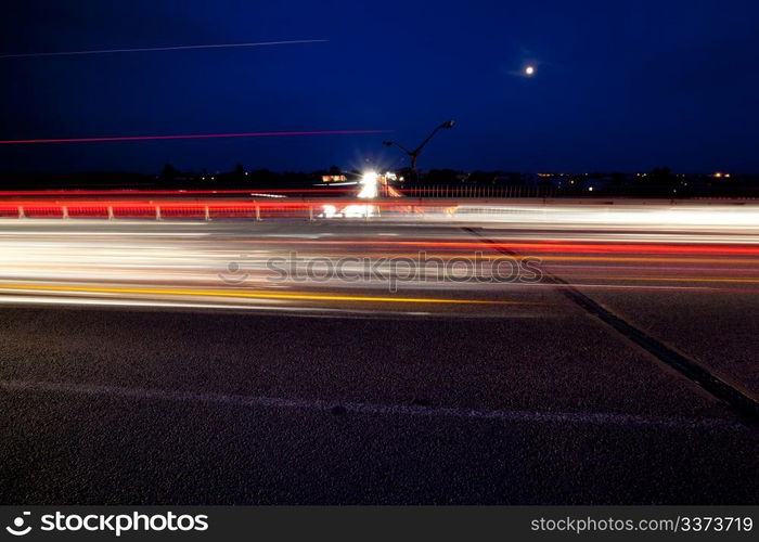 Light trails of evening highway. Urban background