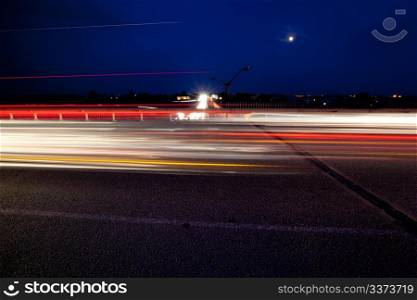 Light trails of evening highway. Urban background
