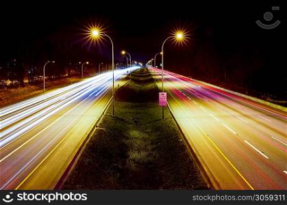 Light trails on highway at night. View from pedestrian overpass