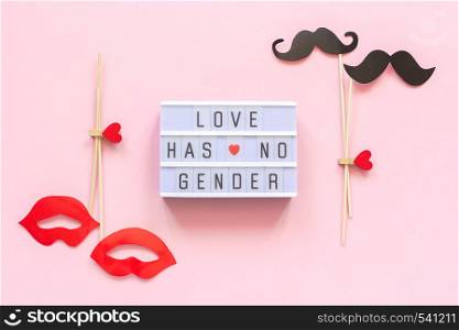 Lightbox text Love has no gender, couple paper mustache lips props on pink background. Concept Homosexuality gay love National Day Against Homophobia or International Gay Day Top view Greeting card.. Lightbox text Love has no gender, couple paper mustache lips props on pink background. Concept Homosexuality gay love National Day Against Homophobia or International Gay Day Top view Greeting card