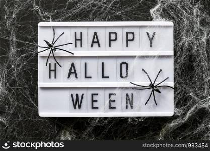 Lightbox with text Happy halloween decorated cobwebs and spiders, closeup. Halloween concept, Top view, Flat lay, Template for greeting card.. Lightbox with text Happy halloween decorated cobwebs and spiders, closeup. Halloween concept, Top view, Flat lay, Template for greeting card