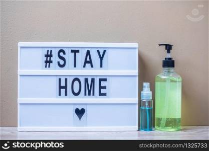 lightbox with text #STAY HOME, hand alcohol gel or sanitizer on table. Coronavirus, Covid-19, Quarantines and Social Distancing concept